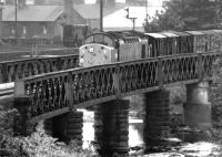 D224 crossing the River Caldew at Dentonholme on the Carlisle goods lines with an up freight in December 1968. The Dentonholme goods depot shunter stands in the background. [See image 14716]<br><br>[John Furnevel 08/12/1968]