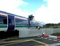 An Aberdeen - Inverness train at speed (and how) over Kinloss level crossing in September 2004.<br><br>[John Furnevel 12/09/2004]