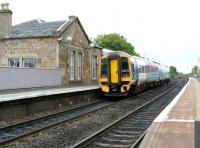 Platform view looking east at Linlithgow in May 2005 as a train for Edinburgh leaves the station.<br><br>[John Furnevel 11/05/2005]