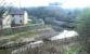 Remains of the bridge carrying the former NB line across the Water of Leith from Bonnington East to Bonnington South Junctions in March 2003 [see image 5635]. The line continued on to Powderhall station on the site of which the waste disposal depot can be seen in the distance.<br><br>[John Furnevel 10/03/2003]