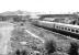 A Glasgow - Leeds train shortly after restarting from Dumfries in 1982, passing the site of Dumfries shed, with the buildings now demolished. This view from St Mary's Street bridge had not been possible prior to demolition of the old shed.<br><br>[John Furnevel 18/06/1982]