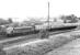 A down Leeds - Glasgow train passing the former <I>Lighthouse</I> signal box that still stood on the hill to the north of Dumfries station in the early 1970s. In the words of renowned railway photographer Derek Cross, the historic structure was <I>'...demolished in an act of planning vandalism.'</I> Nearest the camera is the remaining section of <I>The Port Road</I> to Stranraer, still open at this time as far as the ICI factory at Cargenbridge, just beyond Maxwelltown.<br><br>[John Furnevel 18/06/1971]