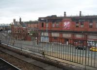 The derelict but substantially intact Manchester Mayfield station, as seen from the Deansgate line island platform at Piccadilly. This picture shows the main station building, the approach ramp and the trainshed behind. Mayfield was seen as an extension of the then London Road (later Piccadilly) station but closed to passengers in 1960, following which it was for a long time used for parcels trains. Over the years there have been numerous proposals for this prime city centre site, including reopening to rail traffic, but nothing has yet transpired. [See image 30526]<br><br>[Mark Bartlett 09/07/2010]
