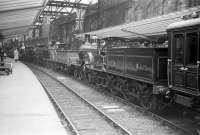 An exhibition of vintage locomotives and rolling stock at Carlisle platform 6 in June 1958. The locomotive nearest the camera is the preserved Samuel Johnson Midland Railway <I>Spinner</I> no 118 (later no 673). This locomotive is now a static exhibit at the NRM in York.<br><br>[Robin Barbour Collection (Courtesy Bruce McCartney) 07/06/1958]