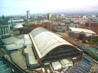 View over Manchester Central from the Beetham Tower on 28 September 2009. Closed to rail traffic in 1969 the old CLC station was subsequently refurbished and relaunched as the G-Mex Conference and Exhibition Centre in 1986 before regaining its original identity in 2008. The Midland Hotel stands opposite the far end of the building and a Metrolink tram can be seen running past on the right. <br><br>[Ian Dinmore 28/09/2009]