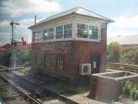 Goonbarrow Junction signal box, as seen from the window of a Newquay to Par service on 15 June 2010. The train has just called to surrender the staff for the long single line section from Newquay and pick up the token for the next section to St. Blazey. [See image 26480] for a panoramic view of the China Clay works just visible in the background of this picture.<br><br>[Mark Bartlett 15/06/2010]