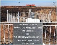 Class E18 locomotive no 18 320 in Transnet livery hauls two wagons of rails past the sitewhere Winston Churchill was captured by Boer forces in 1899. The spot is approximately half way between Estcourt and Colenso in South Africa's KwaZulu-Natal province. A close-up of the commemorative marker is shown below.<br><br>[John Gray 02/08/2010]