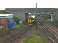View south at Barassie on 27 July 2010 as the 11.07 Kilmarnock to Girvan negotiates the junction. Signal box to the left<br>
<br><br>[Colin Miller 27/07/2010]