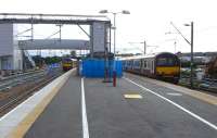 Platform 3 at Airdrie takes shape on 14 August 2010. A recent arrival stands at platform 2 while a westbound service is in the process of departing from bay platform 1.<br><br>[David Panton 14/08/2010]