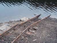 Close up of the narrow gauge rails that were possibly laid as a maintenane track and, long disused, are normally under the water in Grizedale reservoir but have been <I>on show</I> through the summer droughts. There are no quarries nearby and it may be that they were used to transport dam construction materials up the Grizedale valley around 1866. Can anyone confirm this? <br><br>[Mark Bartlett 16/08/2010]