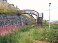 In need of refurbishment, the half footbridge east of the site of Buckpool station (of which nothing remains) on the Moray Coast line, seen here on 22 August 2010. <br>
<br><br>[John Gray 22/08/2010]