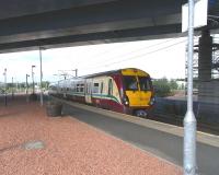 Temporary decks are down on the bridge carrying the M74 extension <br>
over Rutherglen station further changing the character of the formerly rather exposed platforms. It will change even more when traffic starts thundering overhead (whenever that might be). 334 013 pulls in with a southbound service on 14 August. <br>
<br><br>[David Panton 14/08/2010]