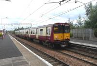 The driver of 314 205 has changed ends at Newton on 14 August and is ready to return to Glasgow, this time via Maxwell Park. There is no reason why these trains from the Cathcart lines can't continue towards Motherwell, as they have done in the past [see image 30117], but for decades now these services have stuck to their rigid timetable, leaving the lines beyond Newton East Junction to Argyle Line services.<br><br>[David Panton 14/08/2010]