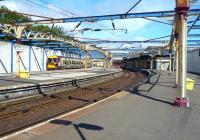 Sunshine on Gourock. With work now underway on the new station, scenes like this will soon become a memory. The 11.23 Gourock - Glasgow Central service bides its time at platform 3 on 29 July 2010. [See image 30014]  <br><br>[Colin Miller 29/07/2010]
