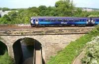 A westbound train on the Edinburgh - Glasgow Central via Shotts route is about to cross the Water of Leith on Slateford Viaduct in June 2010.<br><br>[John Furnevel /06/2010]