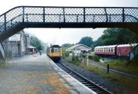 A rainy day at Betws-y-Coed in July 1991 as a dmu departs from the solitary remaining platform bound for Llandudno. To the right is the Railway Museum.<br>
<br><br>[Colin Miller /07/1981]