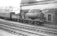 Class J35 0-6-0 no 64509 stands alongside Hawick shed in the summer of 1958. The old coach behind the locomotive is thought to have been the shed's tool van. <br><br>[Robin Barbour Collection (Courtesy Bruce McCartney) 22/07/1958]