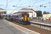 On a fine 1 September 156 467 pulls away from Troon with a lightly <br>
loaded (as usual) Kilmarnock to Girvan service. The station building dates from 1892 and the architect was James Miller. Having supporting girders spanning the tracks was no doubt designed to keep the platforms clear of canopy columns, but it also had the unforeseen benefit of providing handy catenary supports 90-odd years later. And no, that isn't a Nestle's chocolate machine.<br>
<br><br>[David Panton 01/09/2010]