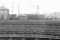 A box camera photograph from 1962 showing the view north across the tracks towards Greenlaw Goods, standing in the 'V' of the Paisley and Renfrew lines to the west of Arkleston Junction. The photograph is taken from the point where the south to west curve of the ill-fated Paisley and Barrhead route from Paisley East would have joined the main line. At this time the abutments of both bridges on the triangle over Greenlaw Drive and Barshaw Drive survived, as did the embankment carrying the planned south to east curve.<br><br>[Colin Miller //1962]