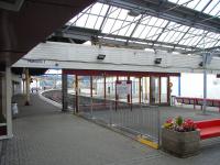 There is a three-platform terminus on either side of the Firth of <br>
Clyde, but the contrast between Helensburgh Central and Gourock is <br>
marked. The former is smartly turned out with a lively air, whereas <br>
Gourock, although it sees more trains, is - well see for yourself in this photograph taken from the concourse on 1 September 2010. There is no glazing in the platform canopies, and the building is unoccupied with the ticket office etc in Portakabins (TM) outside. Happily though an impressive new permanent ticket office nears completion and the platform area is due for a makeover in 2011. <br>
<br><br>[David Panton 01/09/2010]