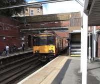 On 11 September, unit 318 266 emerges from Canning Street tunnel into Bridgeton station with a Lanark direct service. Meanwhile, with a train at the opposite platform imminent, all passengers (except possibly the infant) are frantically phoning and texting before they lose the signal for several vital minutes.<br>
<br><br>[David Panton 11/09/2010]