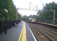 By shooting slightly earlier then my view of 66.725 [see image 30740], one can see the milepost (yellow metal post by the station sign) in the platform fence on the down line, and the spare rail on the up line - conscientiously sandbagged in place.<br><br>[Ken Strachan 17/09/2010]
