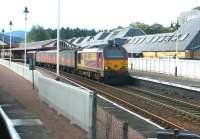 A northbound parcels train halted at the north end of Aviemore station on 25 September 2004 behind EWS 67024.<br><br>[John Furnevel 25/09/2004]