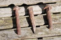 Three vintage bolts found by a householder in a garden to the east side of the former Law Incline (between Dundee Ward Road and the Law Tunnel). Suspected to be screw spikes or track fasteners. They're in not bad shape given line closure in the 1860s. Does anyone know their exact purposes? [Thank you very much for the replies so far.  For completeness here are extracts from three replies; <i>'The left hand one is a chair spike, which was used with a wooden treenail to secure early chairs to wooden sleepers. The right hand one is a bullhead fishbolt. Not too sure about the middle one, some kind of spike or fang bolt?'</i> and from another reply <i>'the centre fixing could well be a spike for fastening down track'</i> and a further comment <i>'if the centre spike has an offset head then it is most likely for fixing an early cast flat bottom rail to a wooden sleeper'</i>.]<br><br>[Ewan Crawford 27/03/2010]