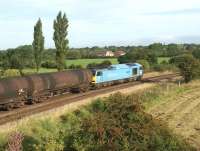 The Lindsey Refinery to Preston Docks tar tank train is seen <br>
dropping down from the East Lancashire line towards Farington Curve Junction for the short run north to Preston with the unique liveried 60074 <I>Teenage Spirit</I> providing a welcome break from the usual Class 66.<br><br>[John McIntyre 25/08/2010]