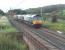 The evening DRS Sellafield to Crewe service approaches the site of Woodacre Crossing (replaced by a footbridge a few years ago) and is just about to cross the Grizedale Beck. 66415 and 66418 are hauling two flask wagons but this train can be very varied. The previous Thursday it ran with two Class 37s and two Class 66s with a single flask wagon and two nights after this picture was taken had two Class 66s, one Class 57 and five flask wagons.  <br><br>[Mark Bartlett 07/09/2010]