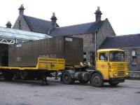 Site of platforms 1-4 at Elgin East in the summer of 1977. By the time of this scene the former passenger station had been transformed into a modern freight depot - notwithstanding the filthy whisky container!<br>
<br><br>[David Spaven //1977]