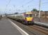 A fine late summer day, and the canvassy smell of warm Ayrshire golf <br>
links wafts across Prestwick Town station. The Ayr-bound 6-car 334 has had little chance to build up any speed from its previous stop at Prestwick International Airport station less than half a mile away.Town station is one of the few with platforms long enough to safely accommodate the forthcoming 8-car 380s, so no lengthening work in eviidence here.<br><br>[David Panton 01/09/2010]