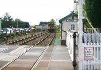 Arriving by car at Poppleton level crossing just as the gates are closing is not recommended for anyone in a hurry. If you happen to be an enthusiast however...  Scene at the crossing alongside Poppleton station on 24 April 2009. The signalman/gatekeeper/station master/ticket collector, whose residence stands opposite, has just prepared the  way for the Northern 150 DMU forming the 13.29 Leeds - York via Harrogate to run into Poppleton station. [See image 30757] <br>
<br><br>[John Furnevel 24/04/2009]