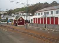 The Derby Castle terminus of the Manx Electric Railway in Douglas is directly outside the horse tram depot. The simple track layout contrasts sharply with the points and crossovers of the horse tramway behind. Arriving electric trains uncouple from their trailer, draw forward and then reverse out of the way. The trailer is then gravity shunted onto the single line in front of the booking office at which point the electric train drops back and couples ready to go back to Laxey and Ramsey. Trains continue to run until the first week in November although there are only four per day each way in Autumn.<br><br>[Mark Bartlett 08/10/2010]