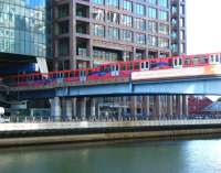 Northbound and southbound services passing at the entrance to Heron Quays station on the London Docklands Light Railway in September 2010.<br><br>[Veronica Clibbery 18/09/2010]