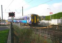 One of the limited stop services on the Glasgow Central - Edinburgh route about to run through Kirknewton station on 12 October. The train is on the well known level crossing which it is planned to replace with an underpass.<br><br>[John Furnevel 12/10/2010]