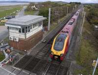 A southbound Virgin Voyager passes 'Hest Bank level crossing frame' on 19 October, with Morecambe Bay and the Lake District fells in the background.<br>
<br><br>[Bill Roberton 19/10/2010]