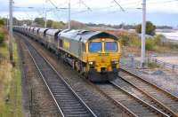 Freightliner 66508 approaches the level crossing with coal empties for Scotland.<br><br>[Bill Roberton 19/10/2010]
