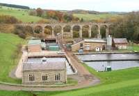 View east from the top of the dam at Fontburn reservoir, Northumberland, on 31 October 2010. Below are the water treatment works of Northumbrian Water, while in the background stands  the 12-arch Fontburn Viaduct that once carried the Rothbury branch of the Northumberland Central Railway. The line saw its passenger service withdrawn in 1952 and closed completely 11 years later.<br>
<br><br>[John Furnevel 31/10/2010]