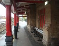 Detail of the canopy and stonework of the original Liverpool and Manchester station building on Platform 2 at Earlestown. In this view, looking along the L&M towards Manchester, a passenger can be seen making the long walk to the platforms on the south to east curve.[See image 31358] The building itself is no longer used but is in a reasonable state of repair.<br><br>[Mark Bartlett 04/11/2010]