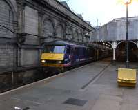 With the yawning, crumpled-looking passengers sent on their way, 90 024 is on the point of pulling out of Waverley's Platform 9 on 20 November with the empty stock of the Caledonian Sleeper from Euston. The current platforms 8 and 9 originally formed a separate station serving the grandly-named Edinburgh Suburban and South Side Junction Railway's trains. Even today that wall makes it feel like you are somewhere else, away from the hubbub of the main station. The awning here is due for a makeover as part of the station's long refurbishment programme.<br><br>[David Panton 20/11/2010]