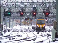 185124 leaves Glasgow Central for Manchester Airport on 6th December 2010. This service, like many others, was running very late due to the heavy snowfalls that day.<br><br>[Graham Morgan 06/12/2010]