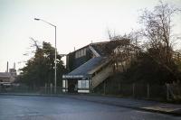 The frontage of Croxley Green LNWR station on Christmas day 1976. Originally, there was a road level booking hall similar in style to that at Watford West at the foot of the steps. This was demolished for road widening in the 1960s. The track formation was also cut back - it used to extend beyond the station into an industrial site. The structure seen here lasted until 1989.<br><br>[Mark Dufton 25/12/1976]