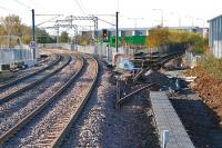 Looking west at more or less the site of the former Bathgate Central Signalbox. To the right is the former approach to Bathgate (Old) with a number of lifted track panels and the line disconnected from the new railway. The rebuilt route to Airdrie is to the left. The former Bathgate Upper station was located to the far left of the green cabins. The view is taken from the west end of the new Bathgate station.<br><br>[Ewan Crawford 31/10/2010]