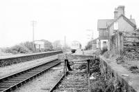 A Metropolitan Cammel 2-car DMU calls at Llwyngwril on its way from Pwilhelli to Machynlleth. Once a reasonably substantial Cambrian Coast two platform station it had by this time been reduced to a plain single line with a disused siding although of course it survives to this day. View north towards Barmouth.<br><br>[Mark Bartlett /05/1980]