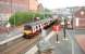 A Helensburgh - Airdrie train photographed during the stop at Coatbridge Sunnyside in May 2005. The square brick-faced pillar reaching up from platform level into the centre foreground of the picture once helped support a street level booking office on Gartsherrie Road. [See image 7765]<br><br>[John Furnevel 09/05/2005]