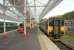 A DMU for Manchester Piccadilly about to leave Halifax on 28 September 2009, shortly after completion of the extensive repainting and reglazing work carried out at the station.<br><br>[Ian Dinmore 28/09/2009]