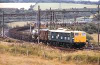 A recently out-shopped class 76, no E26036, approaches Wombwell Main Junction between Worsborough Bank and Wath Yard with a mixed freight from the Manchester area in July 1971.<br><br>[Bill Jamieson 21/07/1971]