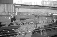 D30 <i>Scott</i> class 4-4-0 no 62423 <I>Dugald Dalgetty</I> stands next to the shed tool van at Hawick on Christmas Eve 1957.<br><br>[Robin Barbour Collection (Courtesy Bruce McCartney) 24/12/1957]