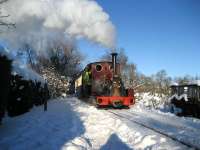 In bright sunshine Quarry Hunslet no 823 <I>Irish Mail</I> brings children (of all ages) through the snow back from <I>Toyland</I> to Becconsall on the West Lancashire Light Railway on 19 December 2010.<br>
<br><br>[John McIntyre 19/12/2010]